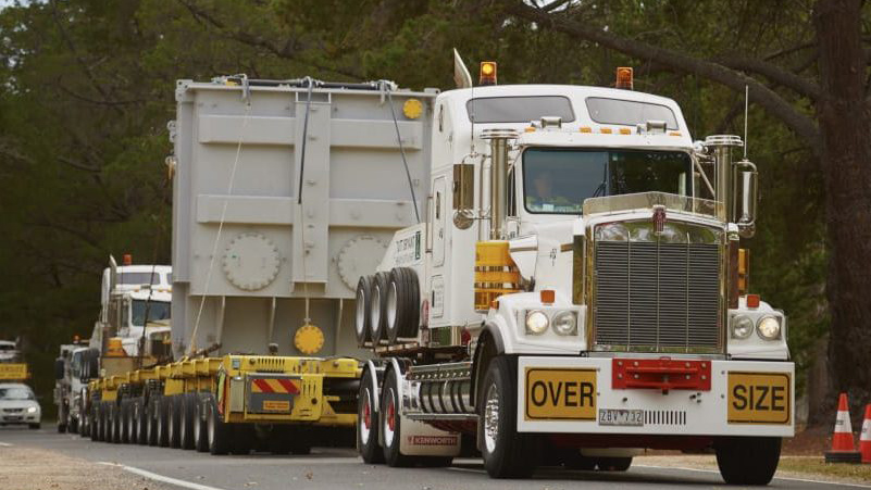 Prime mover truck carrying an oversize trailer
